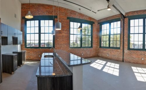 panoramic view of renovated kitchen and dining area in Capewell Lofts luxury apartments